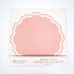 a pink paper placemat sitting on top of a white box with the word modern classics written below it