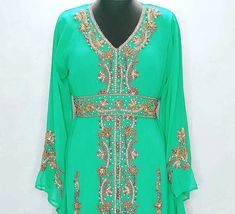 Step out in style with this Green Hand-Beaded Moroccan Kaftan, featuring a vibrant green tone and intricate beadwork. Its loose, breathable design ensures comfort and ease, while its hand-crafted details offer a luxurious flair for both casual and formal events. Green Embroidered Bohemian Kaftan, Fitted Green Embroidered Kaftan, Embroidered Green Kaftan, Luxury Green Sequined Kaftan, Green Embroidered V-neck Kaftan, Moroccan Kaftan, Moroccan Design, African Attire, Hand Beading