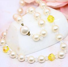 "Striking and unique pearl necklace clear spacer beads and lemon yellow faceted beads with an iridescent finish reflecting flashes of purple and green. White faux pearl beads are a creamy white. Very pretty! Truest colors shown in first pic. Photos show the yellow beads fluoresce under UV light.  Has a button clasp marked JAPAN on the edge.  18\" long Good vintage condition.  Come visit my shop!! https://www.etsy.com/shop/MyMenagerieVintage 💙We are pleased to say that we purchase the vast major Yellow Pearl Beaded Necklaces As Gift, Yellow Beaded Pearl Necklace, Yellow Pearl Necklaces With Round Beads, Yellow Beaded Pearl Necklace Gift, Yellow Beaded Pearl Necklace As Gift, Yellow Pearl Jewelry Gift, Yellow Pearl Necklace Gift, Yellow Pearl Necklace As Gift, Yellow Pearl Necklace For Gift