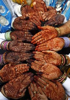 many people are holding their hands together to show off their hendigns and jewelry