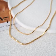 "Experience unmatched elegance with our 18K Gold Filled Herringbone Chain Necklace complemented by a 925s Silver Snake Chain Necklace. Distinctly superior to market alternatives, our necklaces boast of an unrivaled quality and craftsmanship. The lustrous Herringbone design gracefully contours the neckline, while the robust Silver Snake Chain reflects contemporary finesse. Every detail is meticulously fashioned for enduring charm. Don't just take our word for it; witness the exceptional quality firsthand by checking out our detailed video presentation. Gift her not just jewelry, but a promise of unparalleled luxury Material: solid sterling silver filled in 18k gold  Weight: approximately 3.3 grams  Length for 1mm:  40+6 cm Length for 1,5mm: 45+6cm //OUR COMMITMENT: WHAT YOU SEE IS EXACTLY W Gold Herringbone Chain, Herringbone Necklace, Onyx Necklace, Silver Snake Chain, Moon Necklace, Minimalist Necklace, Elegant Jewelry, Snake Chain, Herringbone