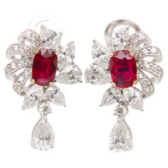 Introducing a timeless creation from Rewa Jewelry, these ruby and diamond earrings are a harmonious blend of classic inspiration and contemporary elegance—an exquisite masterpiece that showcases the brand's dedication to superior craftsmanship and enduring beauty. Inspired by classic design elements, these earrings feature a captivating pair of rubies at the center, totaling 1.60 carats. Certified by Gem Research Swisslab (GRS), these rubies boast the highly sought-after 'Pigeon Blood' Red color Luxury Ruby Earrings With Intricate Design, Elegant Ruby Earrings Gia Certified, Luxury Diamond Earrings With Prong Setting, Ruby Brilliant Cut Fine Jewelry Earrings, Ruby Earrings Brilliant Cut Fine Jewelry, Fine Jewelry Ruby Earrings With Brilliant Cut, Ruby Earrings With Brilliant Cut In Fine Jewelry Style, Ruby Diamond Earrings With Brilliant Cut, Red Diamond Earrings In Fine Jewelry Style