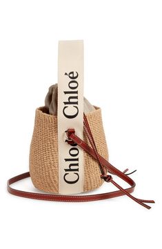 a brown and white bag sitting on top of a red strap