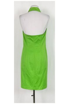 This stunning halter neck dress is perfect for the warm weather. Style it with gold-tone sandals and a chic clutch for a classy day time look. Size 8 - GER 38 96% cotton, 4% elastane Halter neckline Collar Buttons along front Front lace-up pockets Fitted Light discoloration on underarms Small light stain on back of collar Tiny stain on front of dress Bust 33" Waist 31" Shoulder to hem 37.25" Spring Formal Halter Neck Dress, Summer Formal Halter Neck Midi Dress, Summer Formal Midi Dress With Halter Neck, Formal Halter Neck Midi Dress For Summer, Fitted Green Strapless Halter Dress, Elegant Green Halter Dress For Summer, Spring Evening Stretch Halter Dress, Stretch Cotton Summer Midi Dress, Summer Cotton Stretch Midi Dress