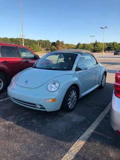 two cars parked in a parking lot next to each other