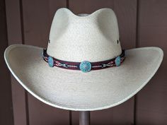 This hitched webbing hatband has a black leather base that is 15mm wide. Copper patina southwest style Conchos accent the band. Ties on with the deertan lace, slide the deer antler bead bead up to "tighten and tie 2 knots in the lace to secure the band. 23" long. Looks great on both palm and felt hats. Hat not included. Traditional Adjustable Hat For Outdoor, Adjustable Western Hat Bands For Themed Events, Artisan Adjustable Hat Bands For Outdoor, Adjustable Western Hat Bands For Rodeo, Adjustable Concho Hat For Festivals, Adjustable Artisan Hat Bands For Ranch, Adjustable Bohemian Hat Bands For Ranch, Adjustable Western Hat Bands For Western-themed Events, Adjustable Western Hat Bands For Festivals