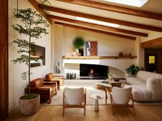 a living room filled with furniture and a fire place in the middle of a room