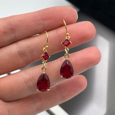 Red Drop Crystal Earrings As Gift, Elegant Red Drop Crystal Earrings, Red Drop Earrings For Pierced Ears, Red Teardrop Drop Earrings, Red Drop Jewelry With Matching Earrings, Red Long Drop Jewelry For Party, Red Ruby Single Earring, Elegant Red Teardrop Earrings With Ear Wire, Red Teardrop Crystal Earrings