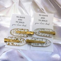 three white and gold hair clips with words to have and to hold you close back