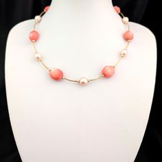 This beautiful necklace showcases a captivating blend of coral and pearls, complemented by 14k gold design elements. The necklace features irregularly shaped, polished coral beads, each displaying unique, natural variations in color and shape, adding to its charm and character. These coral beads are interspersed with lustrous, perfectly round pearls, creating a striking contrast that enhances the necklace's overall allure, while the 14k gold tubes and balls provide a refined and luxurious touch. The necklace is strung on a sturdy metal cord rather than traditional string, offering durability without compromising on elegance, and is finished with a 14k gold clasp for secure closure. This piece is perfect for those who appreciate the unique beauty of natural materials combined with meticulou Elegant Coral Round Bead Necklaces, Elegant Coral Beaded Necklaces, Elegant Coral Pearl Necklace With Round Beads, Elegant Beaded Coral Pearl Necklace, Elegant Red Coral Beaded Pearl Necklace, Elegant Beaded Red Coral Pearl Necklace, Gold Necklace Vintage, 14k Yellow Gold Necklace, Yellow Gold Necklace