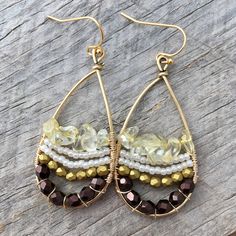 These fun earrings are made with a gold plated drop frame, tarnish-resistant gold plated copper wire, eggplant and gold faceted Czech glass beads, white Japanese seed beads, and citrine chip beads. The ear hooks are 14k gold-plated. These earrings measure 24x47mm and are lightweight. Colors do vary on different monitors; please keep this in mind. ~Care instructions: Not waterproof- do not wear while showering, swimming, etc. As with all jewelry, keep away from children and pets, and store in a d 14k Gold-filled Beaded Drop Earrings, Bohemian 14k Gold Filled Beaded Earrings, Bohemian Beaded 14k Gold Filled Earrings, Bohemian 14k Gold Filled Beaded Dangle Earrings, Bohemian 14k Gold-filled Beaded Dangle Earrings, Beaded 14k Gold Filled Dangle Earrings, Dangle Beaded Earrings With 14k Gold Filled, 14k Gold Filled Beaded Dangle Earrings, 14k Gold-filled Beaded Dangle Earrings