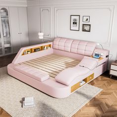 a pink bed sitting on top of a wooden floor