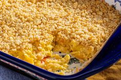 a blue casserole dish filled with eggs and crumbs