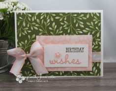 a birthday card with a pink bow on the front and green leaves on the back