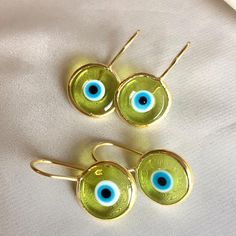 Inspired by our best-selling pendant, the breathtaking blend of colored glass and hand-painted designs in our Antique Evil Eye Earrings is bound to entice and astound. Unique in style and unmatchable in protective beauty, slip them on whenever you wish to make a strong impression, turn heads, and ignite the goddess within. 14k gold plated sterling Transparent eye .5" diameter disk Made by hand in Turkey, each piece is unique Study Core, Painted Designs, Evil Eye Earrings, Gold Baby, Eye Earrings, The Goddess, Evil Eye, Red Gold, Colored Glass