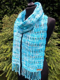 "Gorgeous handwoven scarf in a lace like pattern using a technique called Brooks Bouquet. The yarn is a hand dyed 4ply by Somerset Yarns in their Winter Wonderland colour way. It is 75% Merino and 25% Nylon. Handwoven in Edinburgh by me on my Ashford 20\" loom. Handwash only and dry flat. Approx dimensions: 186cm x 19cm (excluding fringe)." Blue Bohemian Handwoven Shawl, Handmade Blue Shawl For Winter, Blue Silk Scarf As Gift, Bohemian Hand Knitted Scarves As Gift, Blue Shawl Scarf For Gift, Traditional Blue Scarf As Gift, Handmade Blue Yarn Scarves, Handmade Blue Yarn Scarf, Handmade Blue Scarf As A Gift