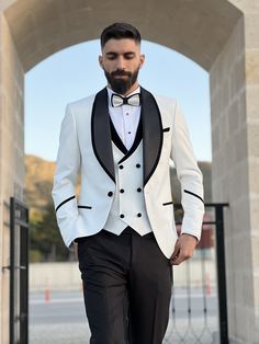 The Black shawl lapel on this tuxedo adds a touch of timeless charm to your modern look. We explore how this classic lapel design perfectly complements the white color, creating a striking balance between tradition and innovation. Package include:  Blazer, vest, pants, bowtie, tuxedo shirt, suit bag  Shipped in large box to preserve the shape  Top quality guaranteed. White Three-piece Wedding Suit, White Three-piece Suit With Notch Lapel For Party, White Fitted Suit And Tie Accessories For Formal Occasions, Luxury White Double Breasted Suit With Notch Lapel, Elegant White Suit And Tie Accessories For Party, White Tailored Blazer For Black-tie Events, White Double-breasted Suit With Notch Lapel For Semi-formal, White Tuxedo For Black Tie Event, White Tailored Tuxedo For Black-tie Events