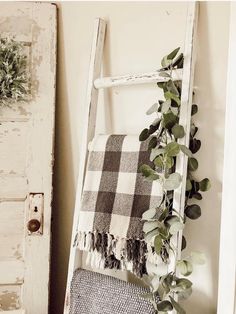 an old ladder is used as a towel rack