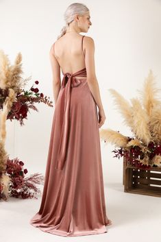 the back of a woman wearing a long pink dress