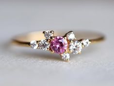 Pink Sapphire Engagement ring, sapphire engagement ring, Cluster engagement ring, Cluster ring, Sapphire and Diamond ring, Birthstone ringSame design can be made also with other custom gemstones per request. Product details:- Solid gold- Diamond - 1.5mm, 2mm, 2.5mm, pink sapphire - 3mm- 1.1mm band- Diamond clarity - VS, Color - E-F- Made to order - 8 to 10 business days.Ring size - US 3 to US 9 (for smaller or larger ring size, please contact)Please select your size at the drop down menu. Servic Pink Sapphire Diamond Ring For Anniversary, Anniversary Pink Sapphire Round Cut Ring, Anniversary Pink Sapphire Ring Round Cut, Wedding Rings In Diamond White Pink Sapphire, Pink Cluster Diamond Ring For Wedding, Cluster Diamond Ring With Accent Stones For Promise, Pink Sapphire Round Cut Promise Ring, Cluster Sapphire Ring With Accent Stones For Anniversary, Cluster Sapphire Ring With Prong Setting For Promise