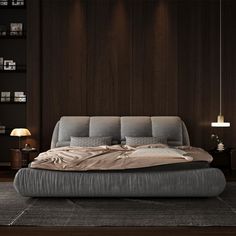 a large bed sitting on top of a wooden floor next to a night stand and lamp