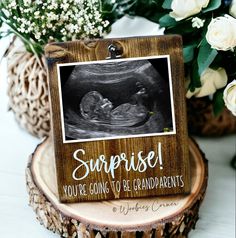 there is a wooden sign that says surprise, you're going to be grandparents