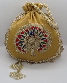 "artisan handmade golden zardosi and thread embroider art deco peacock silk fabric handbag potli bag for woman | indian wedding potli bag Material: Silk Package Contents: As per quantity purchased Size: 10\" x 8\" Designed with the heart, this beautiful Potli or batawa bag are eye catchy and made of premium material. Key Features: Embroidery art work This potli is good match with both Indian and western outfits and are superb for wedding and festive parties This would be best complement to your Cheap Handmade Traditional Shoulder Bag, Bollywood Style Gold Festive Shoulder Bag, Festive Gold Embroidery Potli Bag, Bohemian Gold Embroidered Evening Bag, Bohemian Embroidered Gold Evening Bag, Gold Shoulder Bag With Handwork For Festivals, Bollywood Style Gold Festive Bag, Gold Bollywood Style Festive Bag, Festive Bollywood Gold Bag