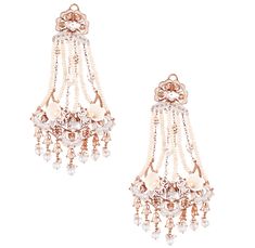 Editor's Note For the love of flexibility and fluidity, endless strands of lustrous pearls, the Swings of Paradise Chandelier Earrings epitomises grace and elegance. Delightfully capturing fluidity, the luxurious power jewel has been artfully sculpted with accents of faunal sighting with a playful mix of Carved melon droplets and Pearl white enamel. Delicately handcrafted to perfection, luxury par excellence, the Earrings are a statement in itself. Material: Brass Plating: 22 KT Rose Gold Care: Outhouse Jewellery, Shell Choker, Charms Necklace, 22 Carat Gold, Bridal Event, Buy Dress, White Enamel, Baroque Pearls, Creative Expressions