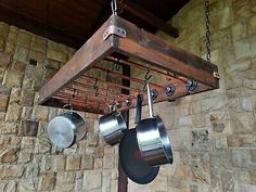 pots and pans are hanging from a rack