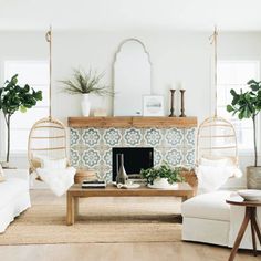 a living room filled with furniture and a fire place in front of a wall mounted mirror