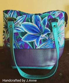 Purple, turquoise, and amaryllis floral color-blocked, large handbag/shoulder bag. Blue Box Bag With Removable Pouch For Errands, Blue Shoulder Box Bag For Errands, Turquoise Crossbody Shoulder Bag With Removable Pouch, Turquoise Crossbody Bag With Detachable Strap, Turquoise Crossbody Shoulder Bag With Detachable Strap, Blue Bucket Shoulder Bag With Top Handle, Blue Bucket Shoulder Bag With Top Carry Handle, Blue Hobo Tote Bag With Top Carry Handle, Blue Hobo Bag With Top Carry Handle