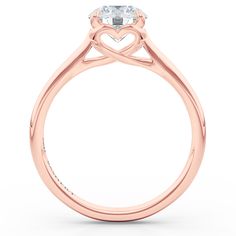 a heart shaped diamond engagement ring on a white background with the center stone in the middle