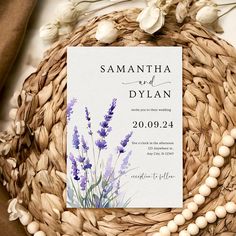 an image of a wedding card on a wicker basket with flowers in the background