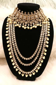 Handcrafted with love to give a real traditional look for this set beautifully studded with polki stones and pearls give a royal look. Includes: Choker, Rani Haar, Earrings, and Tikka Elegant Bridal Earrings With Stone Work And Pearl, Elegant Pearl Bridal Earrings With Stone Work, Bollywood Kundan Bridal Necklace With Pearl Drop, Gold Chandbali Bridal Necklace, Silver Meenakari Pearl Jewelry Sets, Pearl Chandbali Kundan Necklace For Reception, Silver Meenakari Jewelry Sets With Pearls, Gold Chandbali Bridal Necklace For Designer Wear, Silver Pearl Jewelry Set With Meenakari Detail