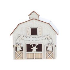 a paper cutout of a white barn with deer