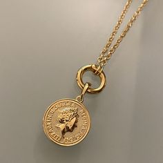 Fine casting made Queen Elizabeth inspired coin pendant in 18k gold filled. A great addition for those looking to have many pendants in a necklace or even bracelet. You may create your own collection, exploring the possibilities of jewelry making or diy (do it yourself) jewelry. Size with bail: 1" length Coin diameter: 0.75 inches Hypoallergenic jewelry Guarantee against tarnish Water resistant Rigorously manufactured under CA Prop 65 and EU standards Made in Brazil Have available the best jewel Handmade Gold Coin Medallion Necklace, Nickel Free Gold Round Disc Coin Necklace, Nickel-free Gold Round Disc Coin Necklace, Gold Coin Necklace Nickel Free, Nickel-free Gold Coin Necklace, Gold Round Coin Necklace Nickel Free, Handmade Gold Coin Necklace With Round Pendant, Gold Coin Necklace With Lobster Clasp As Gift, Gold Plated Tarnish Resistant Coin Necklace