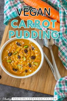 a bowl of carrots and soup on top of a wooden cutting board