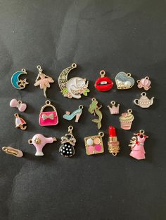 many different types of charms on a black surface