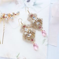 Chandelier statement wedding earrings. Hand embroidered with rhinestone on Venice lace, topped with lovely crystals. Earrings are very light and comfortable to wear, you can order matching bracelet and hair pins (separately). You can as well order earrings in other rhinestone crystals. This earrings will be shipped nicely packed in the gift box. For other wedding jewelry visit my shop; https://www.etsy.com/shop/byPiLLowDesign Gold Jeweled Bridal Earrings For Wedding, Dangle Crystal Earrings With Bling For Wedding, Bling Dangle Crystal Earrings For Wedding, Elegant Jeweled Chandelier Earrings For Wedding, Gold Chandelier Earrings With Crystals For Wedding, Gold Crystal Chandelier Earrings For Wedding, Glamorous Wedding Crystal Earrings With Bling, Jeweled Crystal Earrings For Weddings, Crystal Embellished Bridal Drop Earrings