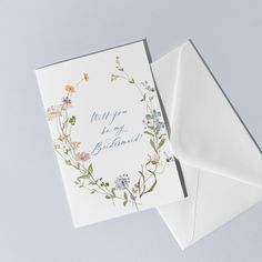 an open envelope with a floral card inside