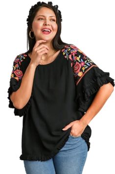 Step up your fashion game with our Floral Embroidered Round Neck Top! Crafted from a luxurious blend of 55% linen and 45% cotton, this top offers both comfort and style. The full front and back of this gorgeous top is a lovely solid go with anything black which provides a chic backdrop for the vibrant, multi-colored embroidery on the sleeves. The unfinished frayed hem adds a trendy, casual touch. Perfect for any occasion, this top is sure to become a staple in your wardrobe. Models are wearing s Bohemian Tops With Embroidered Hem And Relaxed Fit, Bohemian Tops With Embroidered Hem In Relaxed Fit, Fall Embroidered Crew Neck Top, Chic Embroidered Cotton Tops, Floral Embroidered Top For Fall Vacation, Spring Crew Neck Blouse With Embroidered Hem, Spring Embroidered Neckline Crew Neck Top, Floral Embroidered Top For Vacation In Fall, Chic Cotton Blouse With Embroidered Sleeves