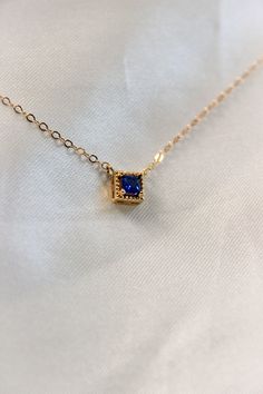 PRODUCT DESCRIPTION Chic and sophisticated, this Diane Necklace is inspired by the glamour of bygone eras. This opulent piece is crafted in 18k Gold-plated or 14k Gold-filled with metal and features a blue square-cut cubic zirconia pendant. Effortlessly elegant and pairs beautifully with day and evening ensembles. You are fine to shower in our gold-filled jewelry. Get it wet, wear it for life! A Dainty yet Elegant Necklace Water and Tarnish Resistant 14k Gold-filled with jeweler's brass (at leas Blue Rectangular Pendant Jewelry For Anniversary, Formal Sapphire Necklace With Rectangular Shape, Blue Rectangular Pendant Fine Jewelry, Elegant Rectangular Gemstone Pendant Jewelry, Elegant Rectangular Pendant Gemstone Jewelry, Blue Rectangular Pendant Jewelry For Formal Occasions, Gold Square Pendant Jewelry For Formal Occasions, Elegant Gold Square Pendant Jewelry, Luxury Blue Square Pendant Necklace