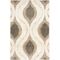 an area rug with brown and white designs on the front, along with a beige background