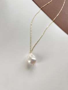 This necklace is made with large baroque pearl, with 14K gold plated S925 Silver chain. Perfect gift for your love ones.  💗  Pearl: 16mm* 27mm Chain will come with 2inches extension in the end **Note from us Freshwater pearls are unique and rarely perfect. Sometimes they will have slight imperfections, small blemishes or irregular shapes. Please feel free to contact us if you have any questions about the order or products information. We will try our best to reply to you within 12 hours. ❤️ Fol Gold Baroque Pearl Pendant Necklace, Gold Baroque Pearl Pendant Chain Necklace, Gold Chain Necklace With Baroque Pearl Pendant, Baroque Pearl Clavicle Chain Jewelry Gift, Baroque Pearl Clavicle Chain Necklace Gift, Delicate Gold Baroque Pearl Necklaces, Gold Baroque Pearl Chain Necklace Gift, Gold Baroque Pearl Necklace With Delicate Chain, Yellow Gold Baroque Pearl Necklace With Adjustable Chain