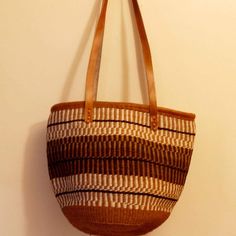 "This is a purely hand woven bag using the finest sisal threads dipped in permanent colors , The basket is mainly weaved using final sisal and handcrafted by rural women from the Akamba community The bag has cotton lining and  leather straps DIMENSIONS ( inches) Height 14 \" x width 12\" ALL orders ship via Dhl Express (3-5 days ) delivery. The bag is ready to ship. Height-14inches  Width-12- inches Closure Zipper" French Market Basket, Rural Women, African Bag, Handwoven Bag, Eco Friendly Bags, Market Baskets, Environment Friendly, Woven Bag, Bag Travel