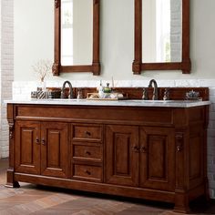 a double sink vanity with two mirrors above it and tiled flooring in the background