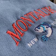 "*SIZES ARE UNISEX* -For women, I'd suggest your usual size for a regular fit (size up for a more relaxed fit). Men should size up for a more relaxed fit. *these sweatshirts are extra comfy when oversized 🐟 \"Montauk New York\" embroidered on a sporty cute vintage-style crewneck. A vintage styled sweatshirt bound to keep you warm in the colder months. A pre-shrunk, classic fit sweater that's made with air-jet spun yarn for a soft feel and reduced pilling. Your new favorite sweatshirt! * 50% cot Blue Crew Neck Hoodie With Embroidered Logo, Casual Crew Neck Sweater With Embroidered Logo, Blue Crew Neck Hoodie With Embroidered Graphics, Blue Sweater With Embroidered Text For Fall, Blue Embroidered Crew Neck Hoodie, Blue Embroidered Text Sweater For Fall, Winter Crew Neck Hoodie With Embroidered Text, Blue Casual Sweater With Letter Embroidery, Casual Crew Sweatshirt With Embroidered Graphics