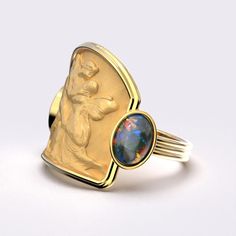 Indulge in luxury with the Love And Psyche Gold Ring. Crafted in ancient style from 14k or 18k solid gold, this Italian-made ring features two natural welo opals that add a touch of elegance and sophistication. Perfect for those with refined taste. 18mm wide on the top, 4,2 mm wide on the bottom side 14k or 18k Gold 0.5 Ct Welo Opal - Dimensions (mm) 7 x 5 x 2,5mm 0.5 Ct Smoked Welo Opal - Dimensions (mm) 7 x 5 x 2,5mm Yellow Bohemian Jewelry With Artistic Design, Unique Yellow Jewelry With Polished Finish, Italian Ring, Shell-shaped Yellow Gold-plated Jewelry, Ancient Gold Collectible Rings, Art Nouveau Yellow Gold Intaglio Jewelry, Neutral Jewelry, Jeweled Earrings, Italian Jewelry