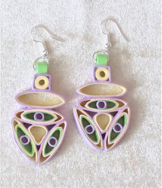 the earrings are made out of wood and have colorful designs on them