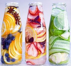 three jars filled with different types of fruit and vegetables